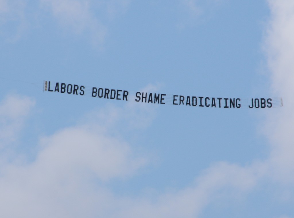 Protest Aircraft displays "LABORS BORDER SHAME ERADICATING JOBS