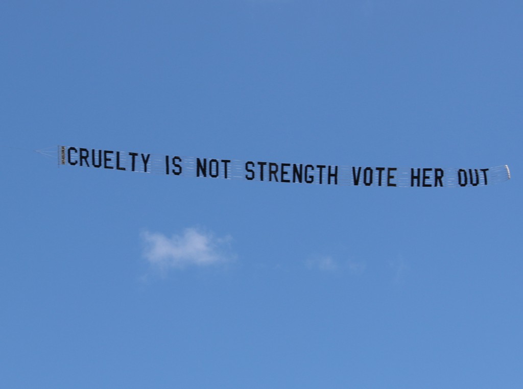 Protest Plane says "Cruelty is not Strength, vote her out"