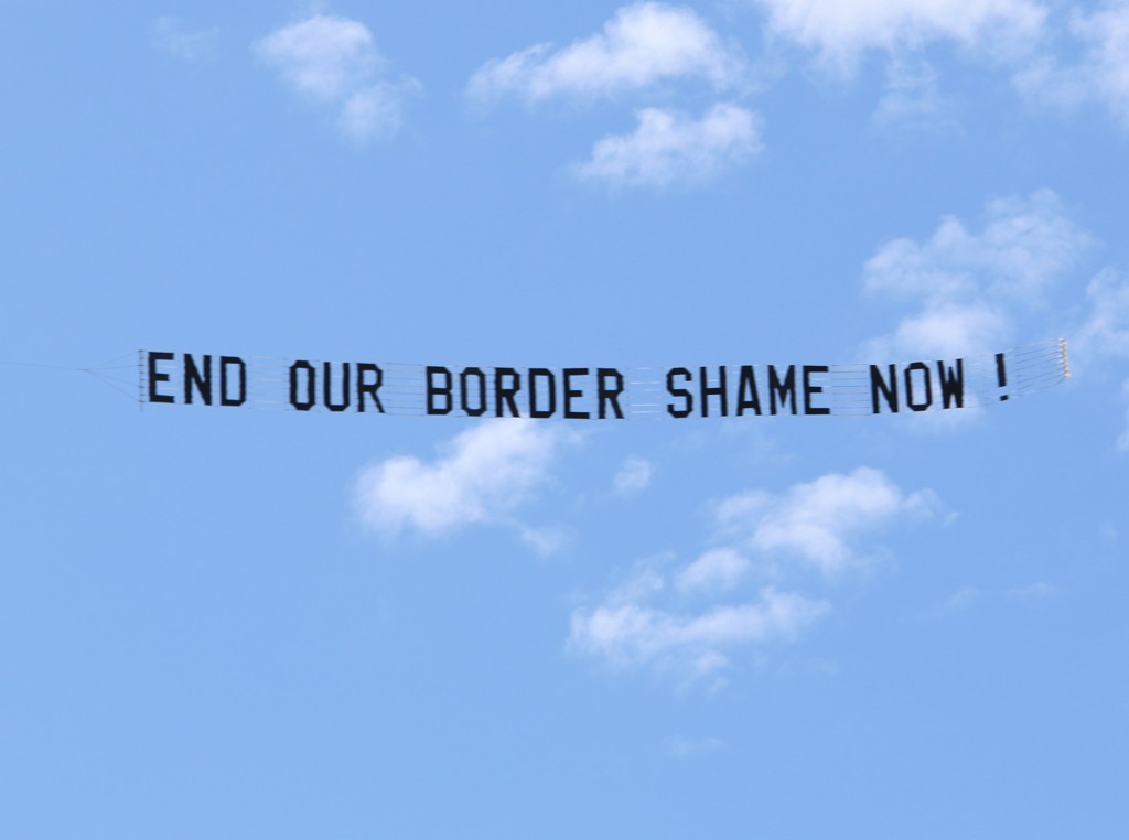 Protest Aeroplane Banner reads "End our Border shame Now !"