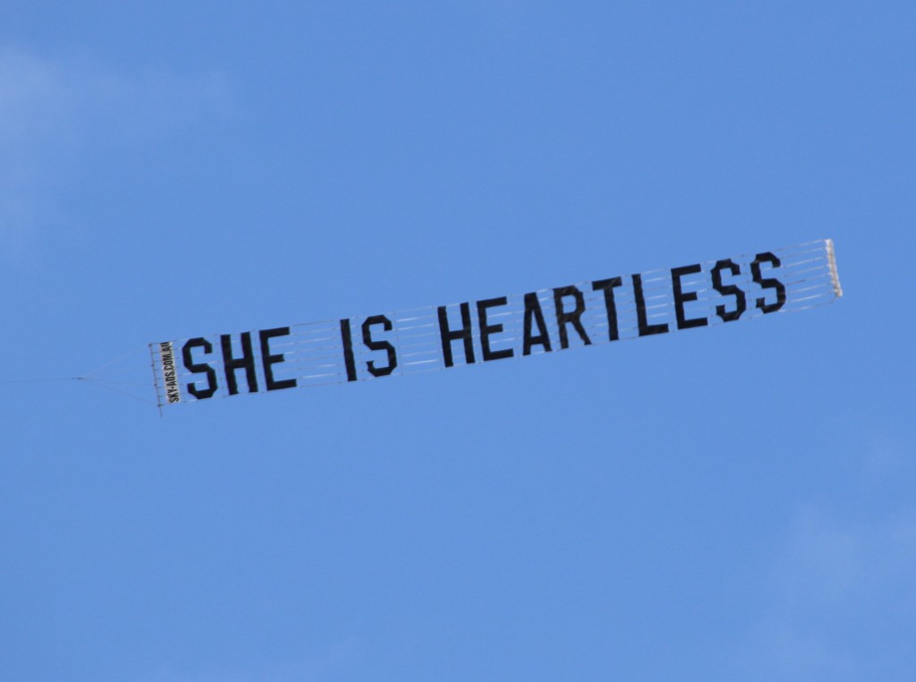 Protest Aircraft dragging sign "She is Heartless"