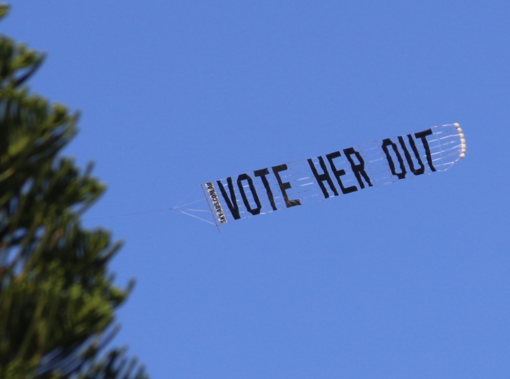 Protest Aircraft sign reads "Vote Her Out"