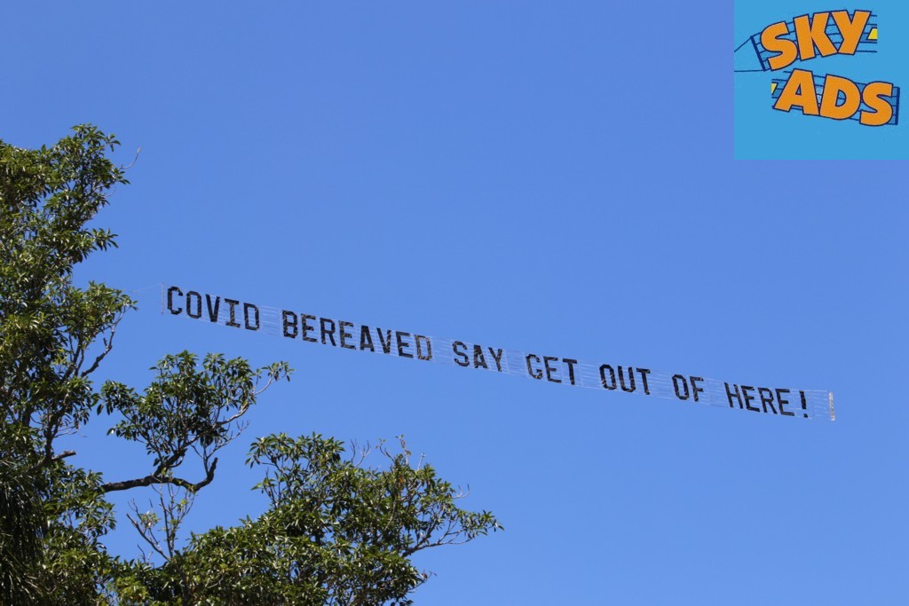 The protest Banner reads "COVID Bereaved say get out of here"